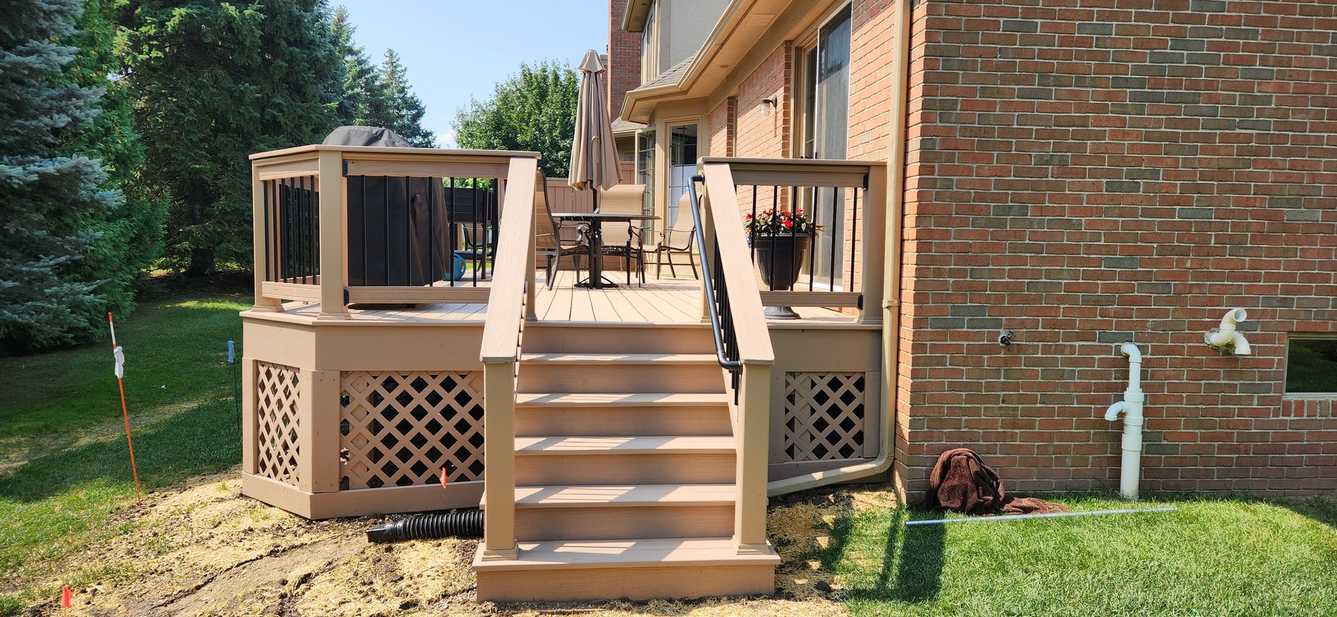 Finished composite deck stairs at brick home