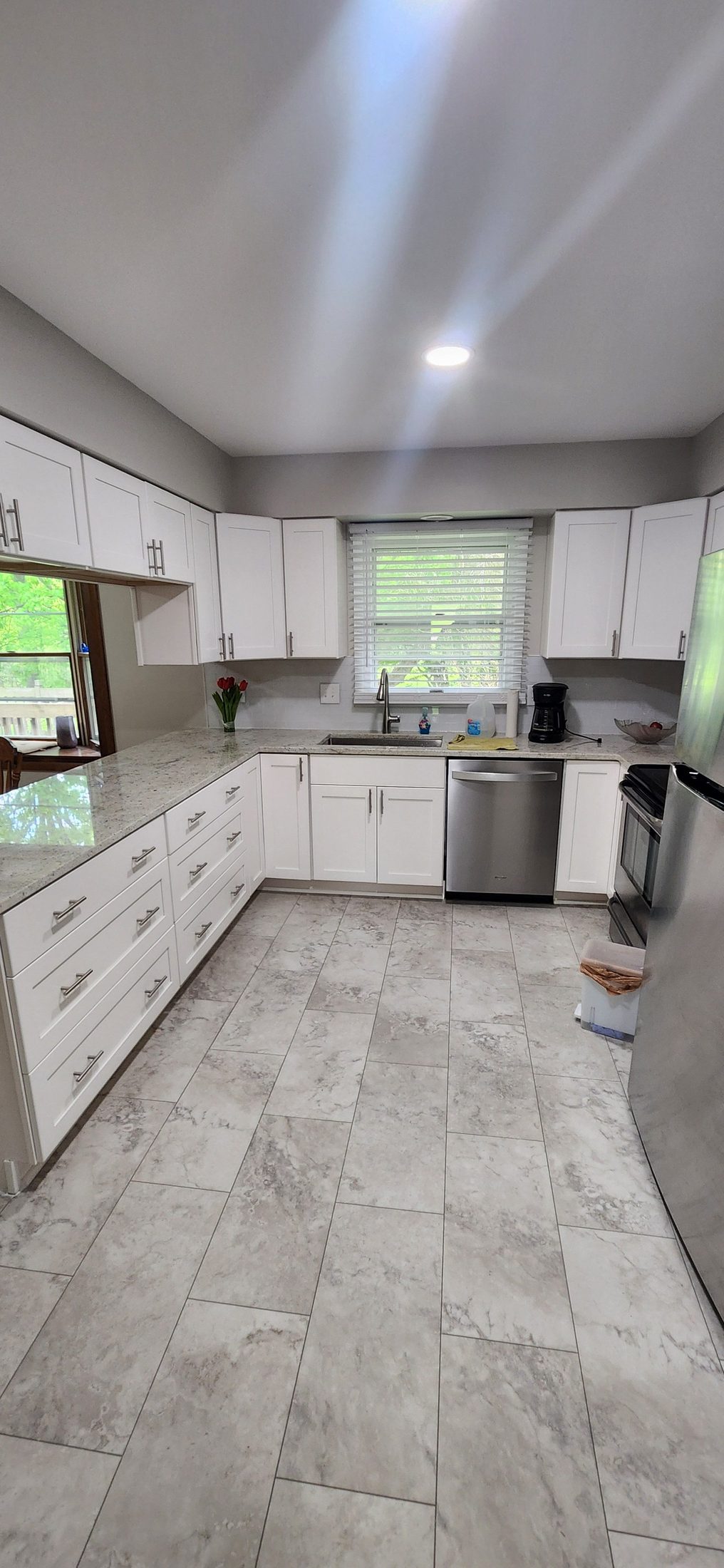 Kitchen remodeling detail with white cabinets and backsplash